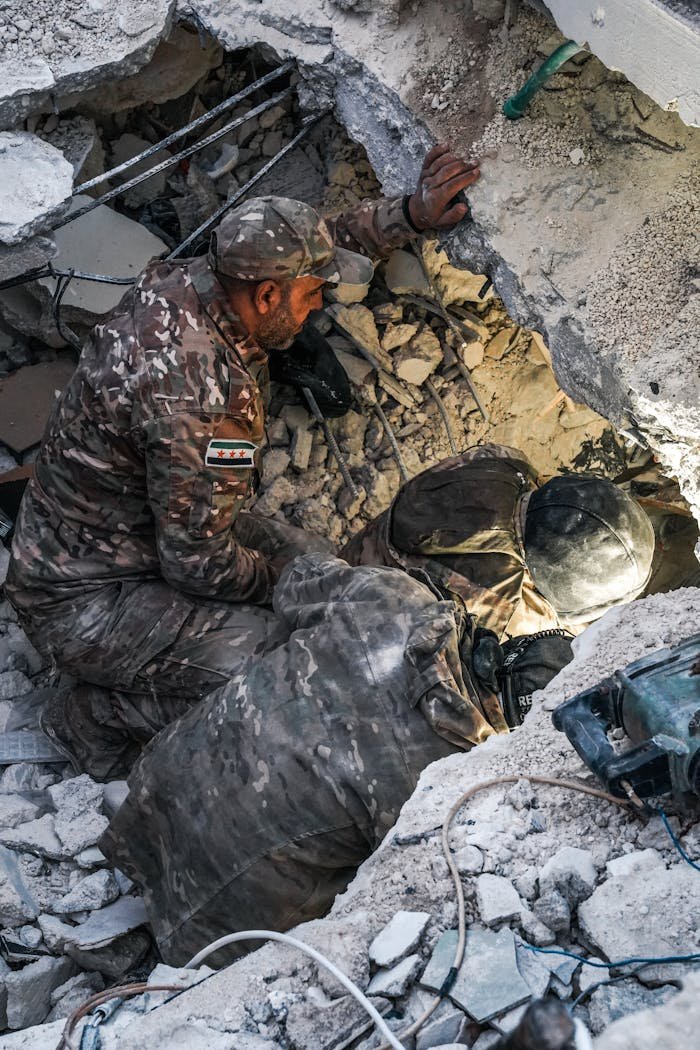 services-01 Rescue workers search for survivors amidst rubble in Jindires, Aleppo after a devastating earthquake.
