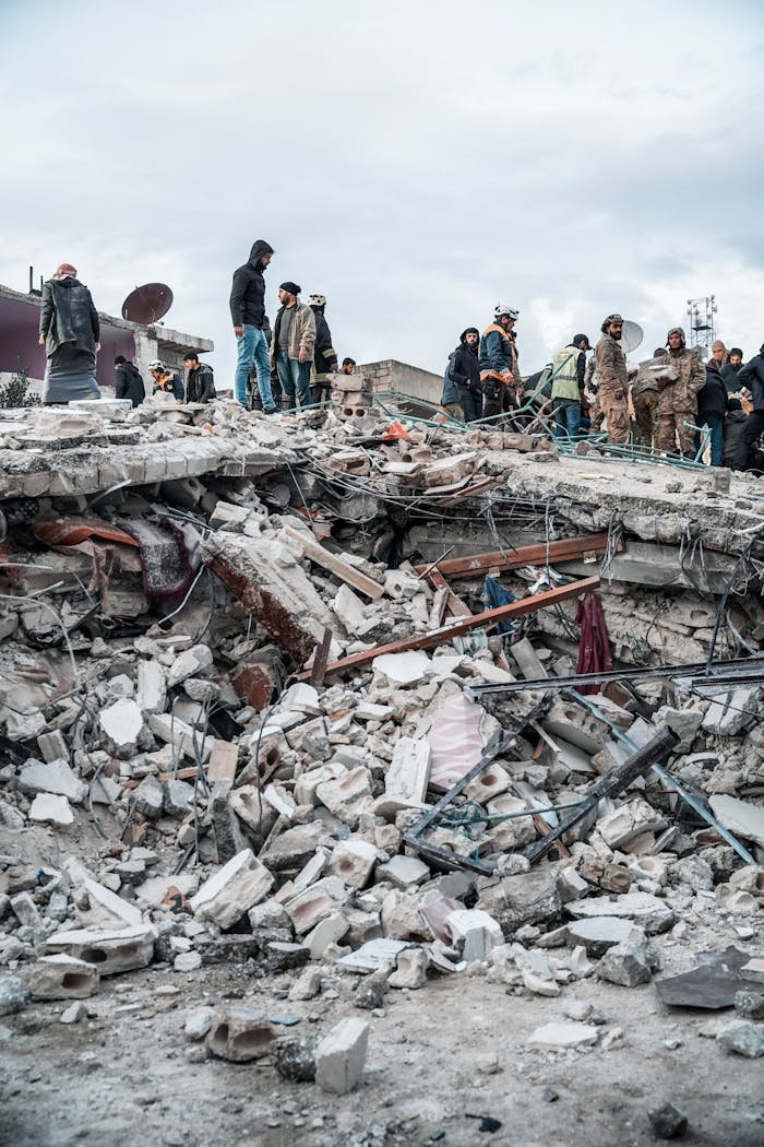 services-04 People inspect rubble after an earthquake in Jindires, Aleppo Governorate, Syria.
